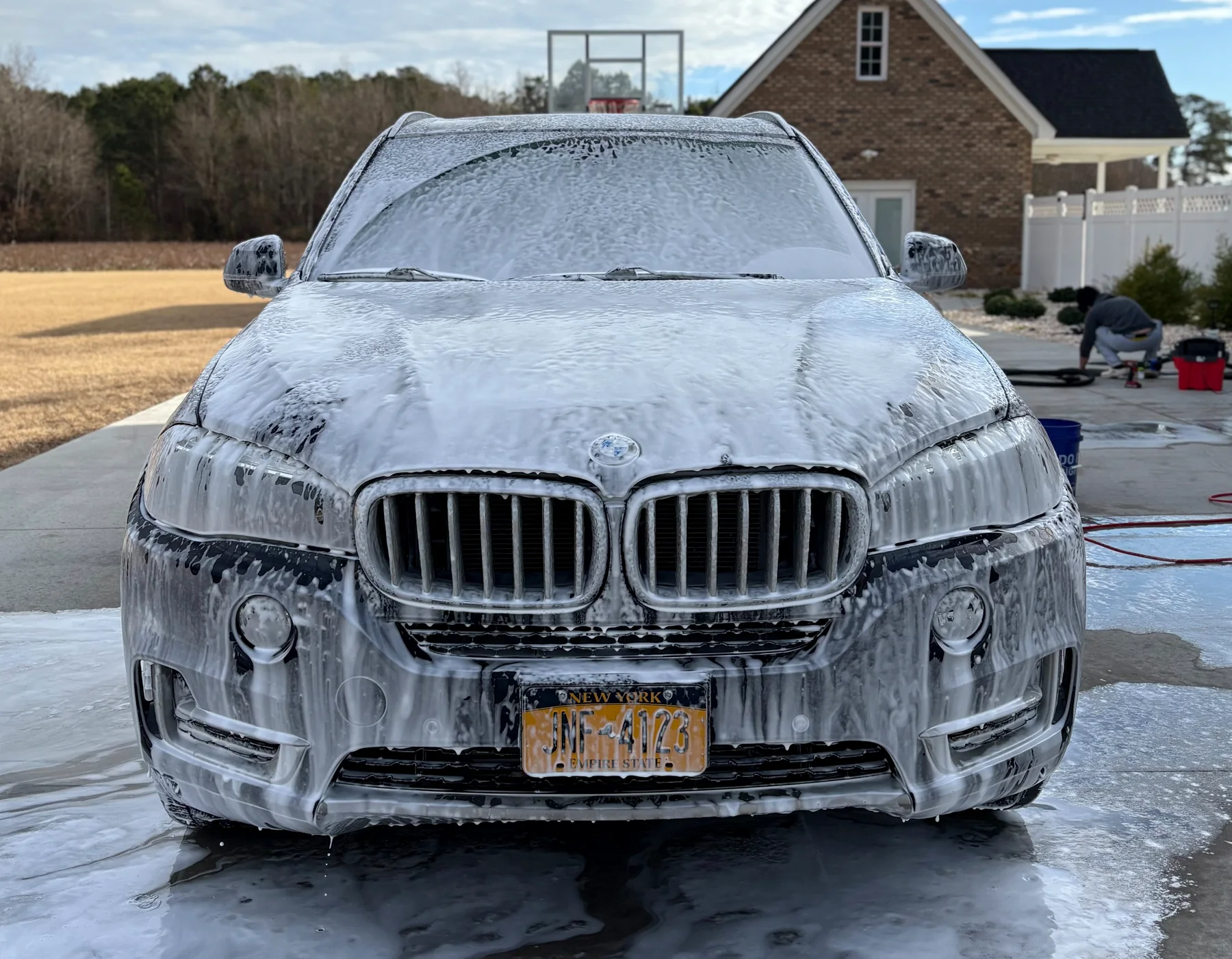 BMW covered in fresh foam during the mobile wash process