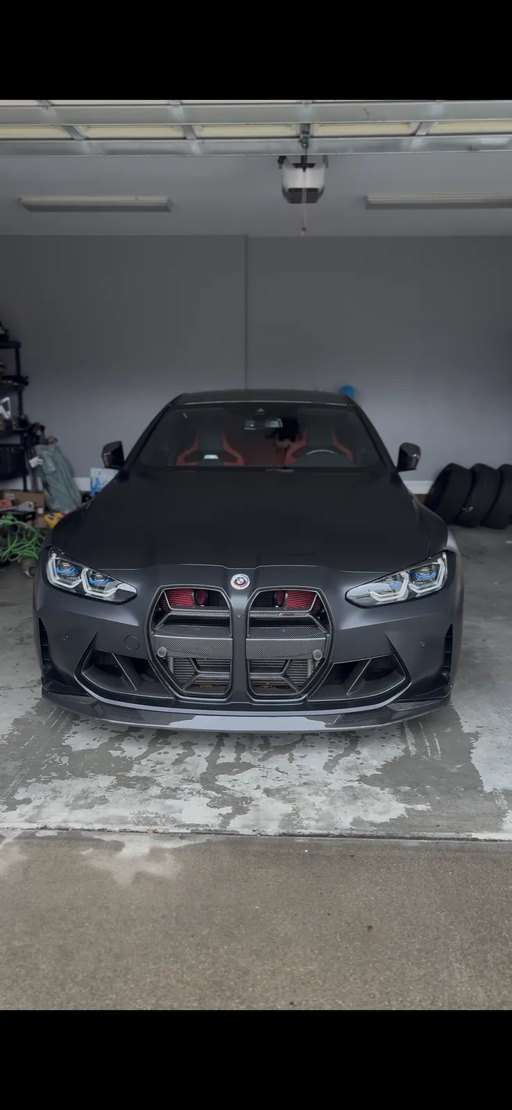 Clean dark BMW parked in a garage after detailing