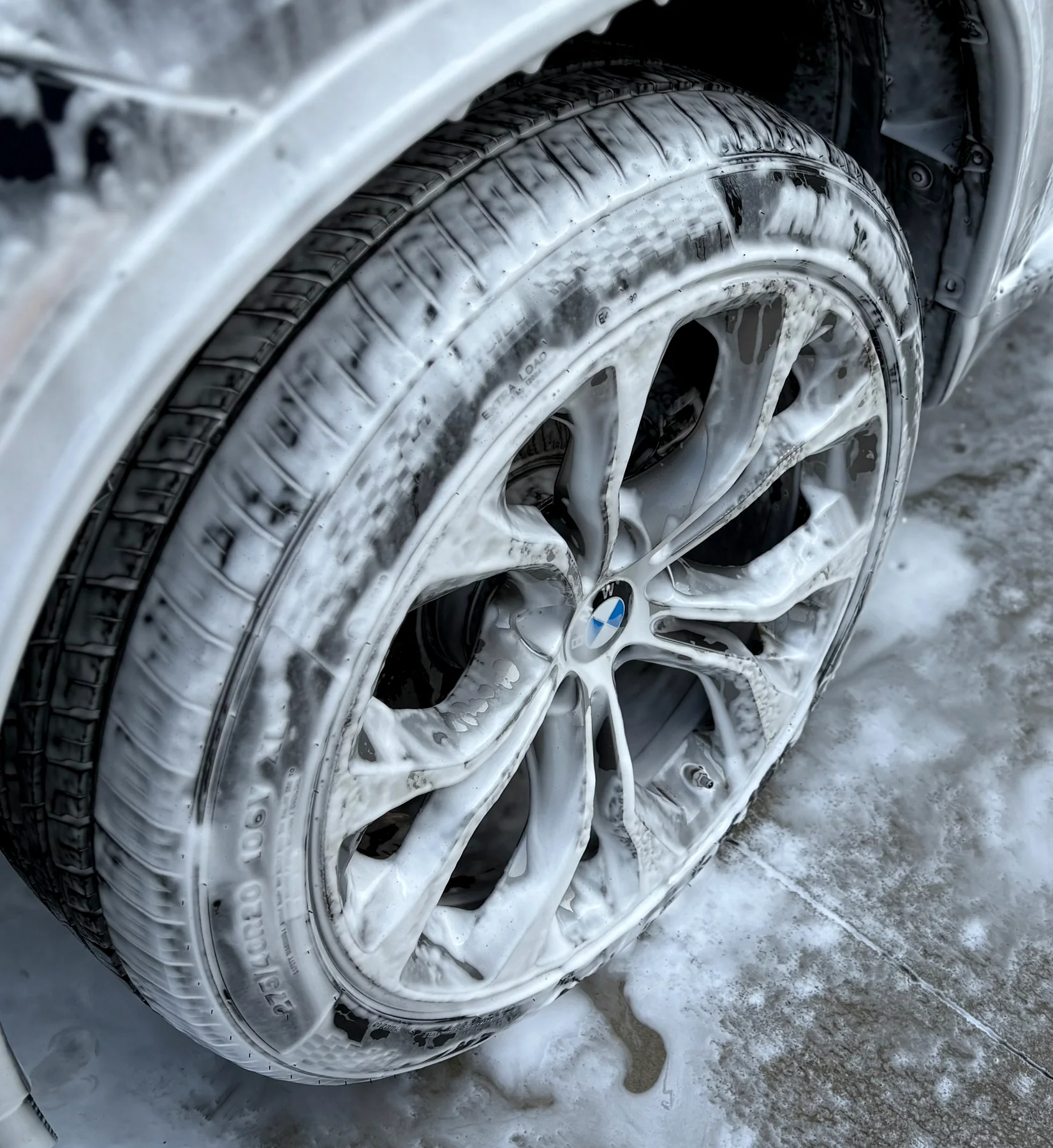 Close view of a clean BMW alloy wheel and tire after washing