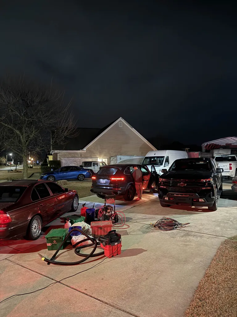 DetailDash mobile detailing equipment and vehicles at a home