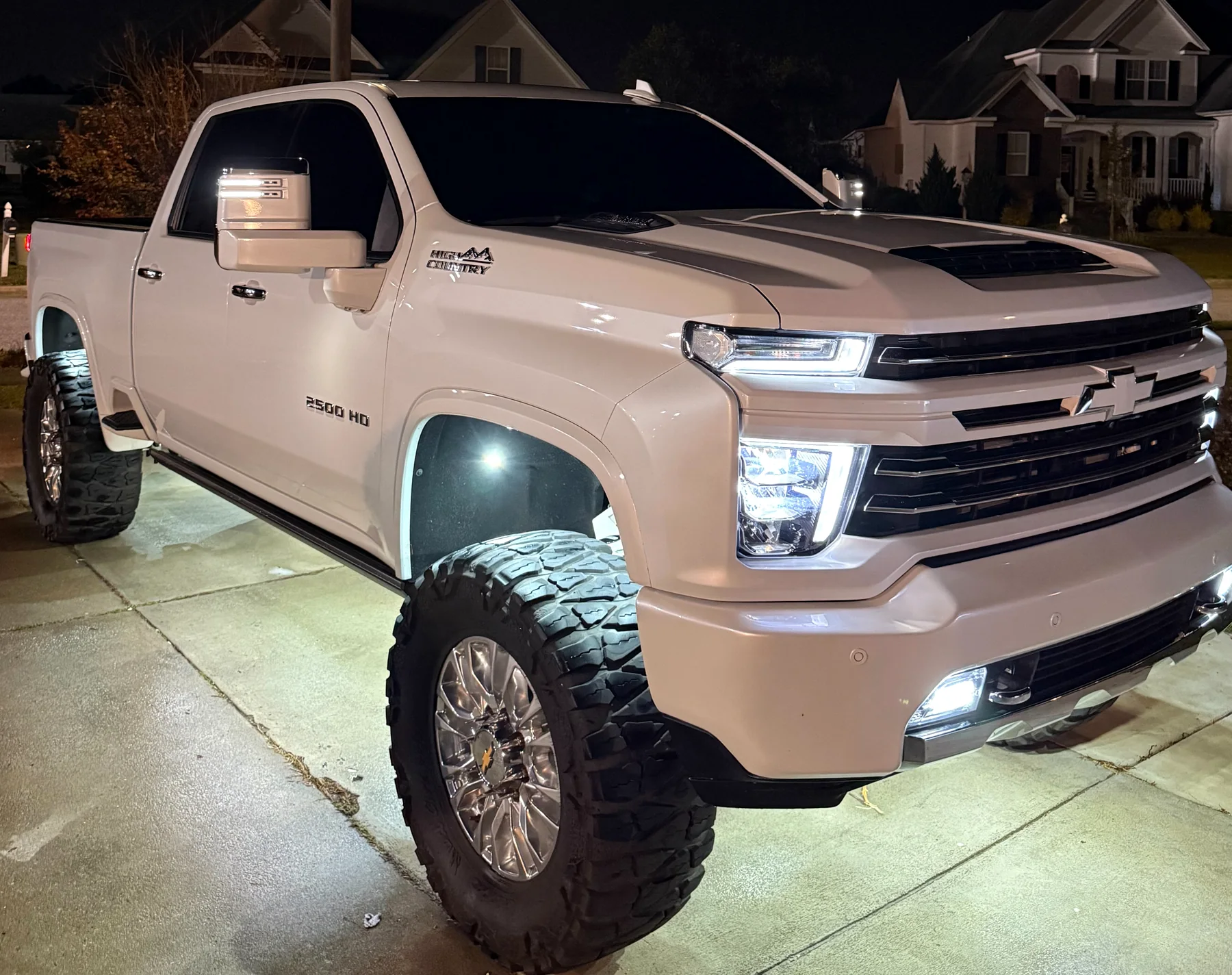 White Chevrolet Silverado with freshly detailed paint and wheels at dusk